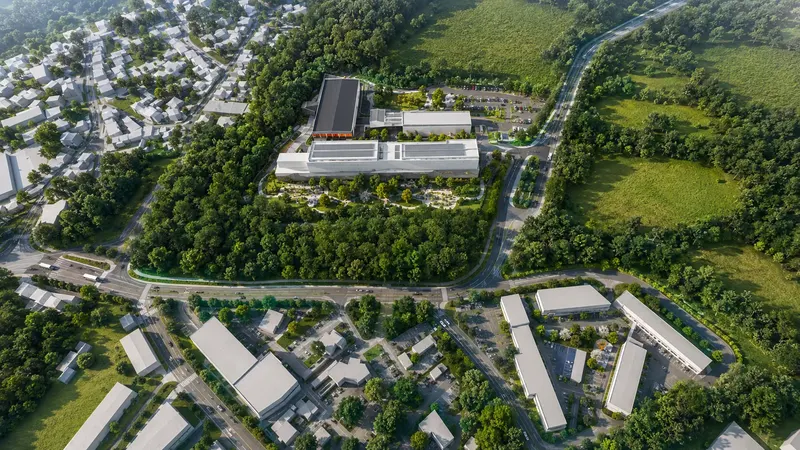 3D vizualizace výrobní haly z ptačí perspektivy s parkovištěm, zelenou střechou a parkovou úpravou